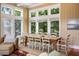 Bright dining area with a large window view, seamlessly connected to the living space, perfect for Gathering meals at 9 24Th Ave, Isle of Palms, SC 29451