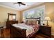 Comfortable bedroom with hardwood floors, a bed with red floral bedding, and a window view at 9 24Th Ave, Isle of Palms, SC 29451