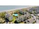 Aerial view of condo complex with pool and beach in the background at 9000 Palmetto Drive # D-304, Isle of Palms, SC 29451