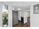 Bright kitchen with stainless steel appliances, white cabinetry, and wood flooring at 9000 Palmetto Drive # D-304, Isle of Palms, SC 29451