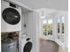 Convenient laundry closet with a washer, dryer, and water heater near a sunlit sitting room at 9000 Palmetto Drive # D-304, Isle of Palms, SC 29451