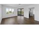 Open-concept living room with balcony access, hardwood floors, and lots of natural light at 9000 Palmetto Drive # D-304, Isle of Palms, SC 29451