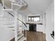 Spacious living area with a spiral staircase, wet bar, hardwood floors, and recessed lighting at 9000 Palmetto Drive # D-304, Isle of Palms, SC 29451