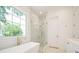 Bathroom with a large window, glass shower, and tub at 1006 Basin Ln, Johns Island, SC 29455