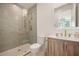 Modern bathroom with glass-enclosed shower, gray subway tile, and wooden vanity at 1006 Basin Ln, Johns Island, SC 29455