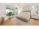 Bright bedroom featuring large windows, light wood floors, and a decorative chandelier at 1006 Basin Ln, Johns Island, SC 29455