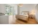 Bright bedroom featuring a rattan bed frame, wood floors and sun-drenched windows at 1006 Basin Ln, Johns Island, SC 29455