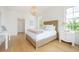 Bedroom with a wood chandelier, woven headboard, and side table at 1006 Basin Ln, Johns Island, SC 29455
