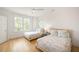 Well-lit bedroom with hardwood floors, white walls, and twin beds positioned near a window for natural light at 1006 Basin Ln, Johns Island, SC 29455