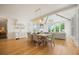 Open-concept dining area flowing into a living space, featuring hardwood floors and modern lighting at 1006 Basin Ln, Johns Island, SC 29455