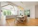 Bright dining area open to a living space, featuring wood floors and modern light fixture at 1006 Basin Ln, Johns Island, SC 29455