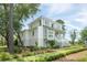 Elegant home featuring detailed woodwork, a well-manicured lawn, and lush landscaping at 1006 Basin Ln, Johns Island, SC 29455