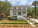 Inviting two-story home featuring a charming porch, manicured lawn, and private driveway at 1006 Basin Ln, Johns Island, SC 29455