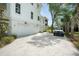 Exterior view of a white three-car garage with a concrete driveway and manicured landscaping at 1006 Basin Ln, Johns Island, SC 29455