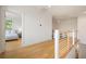 Hallway featuring wood floors and white walls, with view into bedroom at 1006 Basin Ln, Johns Island, SC 29455