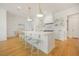 Bright kitchen with an island, marble countertops, modern lighting, and stylish, colorful bar stools at 1006 Basin Ln, Johns Island, SC 29455