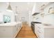 Gorgeous white kitchen features marble counters, stainless appliances, and an island with a sink at 1006 Basin Ln, Johns Island, SC 29455