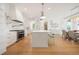 Elegant white kitchen with stainless steel appliances, a large island, and stylish pendant lighting at 1006 Basin Ln, Johns Island, SC 29455