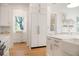 Bright kitchen featuring custom white cabinets, stainless steel appliances, and wood flooring at 1006 Basin Ln, Johns Island, SC 29455
