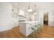 Stunning white kitchen features a large island with barstool seating, chef's stove, and open shelving at 1006 Basin Ln, Johns Island, SC 29455