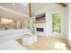 Bright living room with white fireplace, wood beams, and large windows overlooking the yard at 1006 Basin Ln, Johns Island, SC 29455