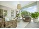 Relaxing screened-in porch with ample seating, decorative pendant lighting, and views of the verdant landscape at 1006 Basin Ln, Johns Island, SC 29455