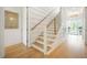 Bright staircase featuring wood treads, white risers, and a modern railing design at 1006 Basin Ln, Johns Island, SC 29455