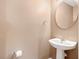 Neat powder room features a round mirror and pedestal sink with neutral-toned walls at 104 Buchanan Cir, Goose Creek, SC 29445