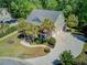 Areal view of the home featuring a beautiful entryway, palm trees and a circle driveway at 105 Aviary Ct, Summerville, SC 29483