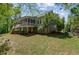 Exterior view of the home with a screened porch and lush greenery at 105 Aviary Ct, Summerville, SC 29483