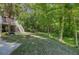 Private backyard includes fire pit, mature trees and a lush lawn at 105 Aviary Ct, Summerville, SC 29483