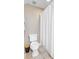 Bright bathroom featuring a white toilet, a shower with a white curtain, and neutral tile flooring at 105 Aviary Ct, Summerville, SC 29483
