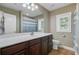Bright bathroom featuring a large mirror, vanity with cabinets, and a window with natural light at 105 Aviary Ct, Summerville, SC 29483