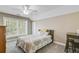 Bright bedroom with a ceiling fan, large window, and a bed with colorful bedding at 105 Aviary Ct, Summerville, SC 29483