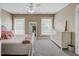Bright, carpeted bedroom featuring a ceiling fan, many windows, and neutral decor at 105 Aviary Ct, Summerville, SC 29483