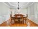 Formal dining room with a chandelier, wainscoting, and hardwood floors, ideal for entertaining at 105 Aviary Ct, Summerville, SC 29483