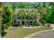 Charming two-story home with a landscaped yard and palm trees, creating a tropical oasis at 105 Aviary Ct, Summerville, SC 29483