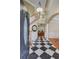 Inviting foyer with black and white tile flooring, staircase, and elegant architectural details at 105 Aviary Ct, Summerville, SC 29483