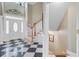 Elegant foyer boasting a striking black-and-white tile floor, grand staircase, and stylish front door at 105 Aviary Ct, Summerville, SC 29483
