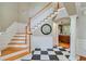 Elegant foyer with checkerboard tile and staircase, showcasing architectural details at 105 Aviary Ct, Summerville, SC 29483
