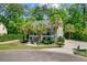 Exterior view of the home featuring palm trees, a circle driveway, and a beautiful entryway at 105 Aviary Ct, Summerville, SC 29483