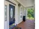 Covered front porch featuring a stylish front door and elegant outdoor lighting fixture at 105 Aviary Ct, Summerville, SC 29483