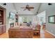 Inviting living room with fireplace, TV, ceiling fan, and views to outdoors at 105 Aviary Ct, Summerville, SC 29483