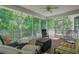 Enjoy bug-free relaxation on screened porch with wood floors and wooded views at 105 Aviary Ct, Summerville, SC 29483