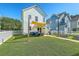A well-manicured backyard features a patio with comfortable seating and a charming white picket fence at 107 Amaranth Ave, Summerville, SC 29483