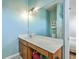 Bathroom features a vanity with a white countertop, a large mirror, and turquoise walls at 107 Amaranth Ave, Summerville, SC 29483