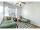 A shared bedroom features two beds, a large window with blinds, and hardwood floors at 107 Amaranth Ave, Summerville, SC 29483