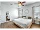 Bright bedroom with wood floors, a ceiling fan, large windows, and a mirror on the wall at 107 Amaranth Ave, Summerville, SC 29483