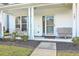 Cozy front porch features seating and a well-lit entryway, and is adorned by landscaped beds at 107 Amaranth Ave, Summerville, SC 29483