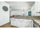 Modern kitchen with granite countertops, white cabinets, stainless steel appliances, and an open floorplan at 107 Amaranth Ave, Summerville, SC 29483